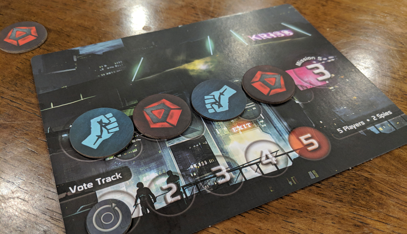 There’s a match card at the centre of the table. This one is going down to the wire, with the resistance (blue) and the man (red) tied at two missions each. First team to three wins is the winner.